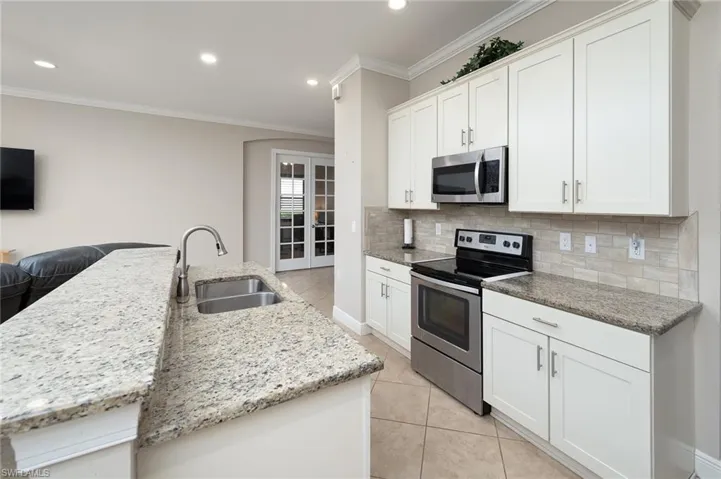 Stainless appliances, nice cabinets with granite countertops, step in pantry, island with breakfast bar.