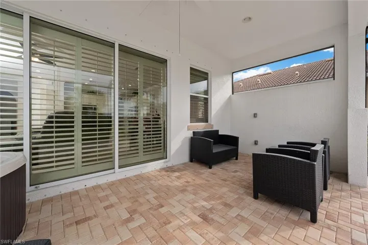 Spacious back lanai with covered seating area and sunning area w/hot tub and room for a pool.Plantation shutters inside sliding doors