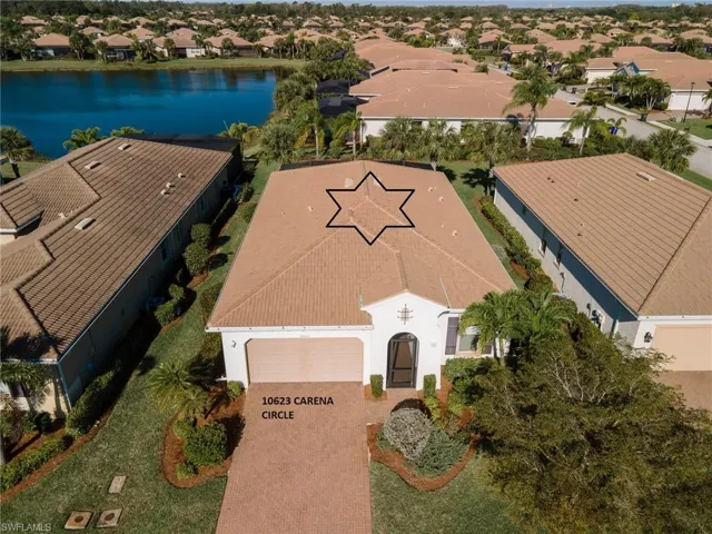 Front view shows large back yard and lake