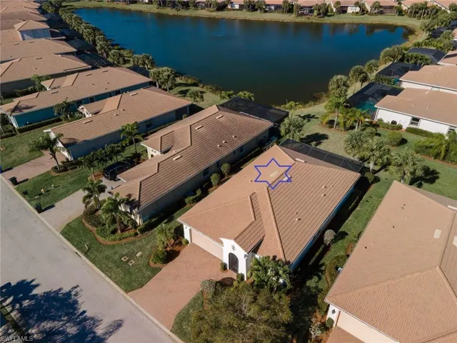 Front view shows large back yard and lake