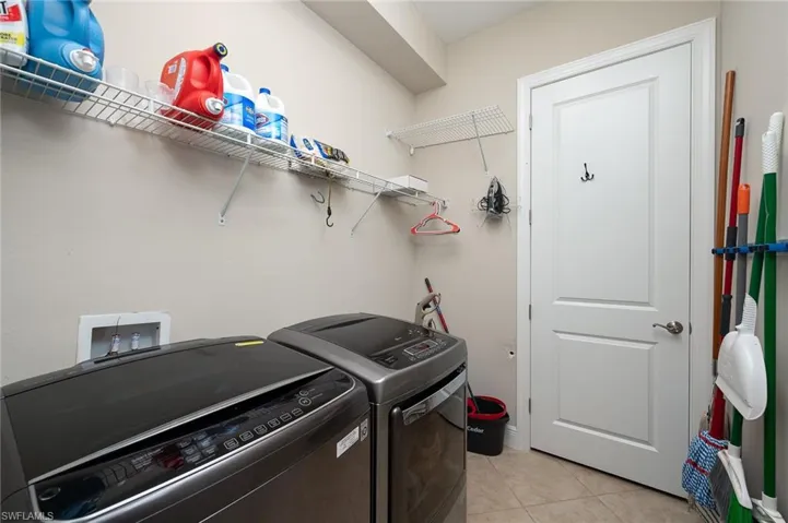 Door to large Laundry Room with smart washer.