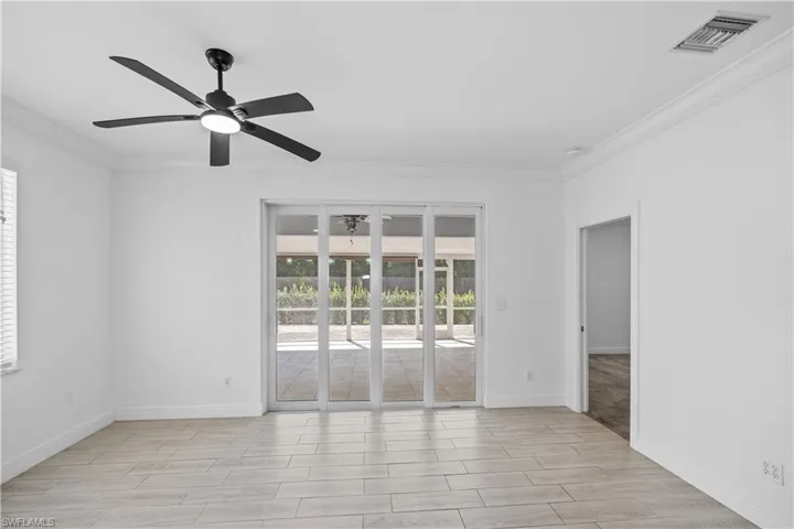 Dinning room featuring tiled floors, a ceiling fan, tons of natural lighting, and impact sliding door