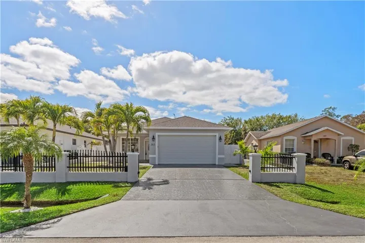 Single story home featuring a fenced front yard with remote controlled entry gate and driveway.