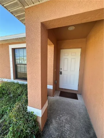 Property entrance with stucco siding