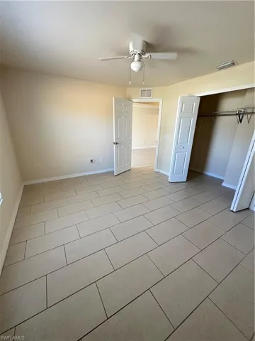 Unfurnished bedroom featuring a closet and a ceiling fan