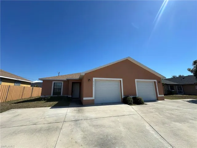 Ranch-style house with stucco siding, concrete driveway, and a garage
