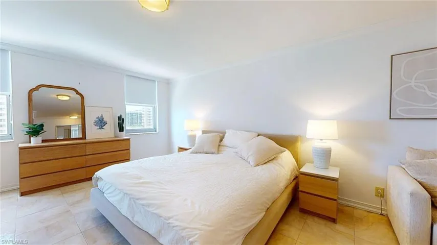 Bedroom featuring crown molding and light tile patterned floors
