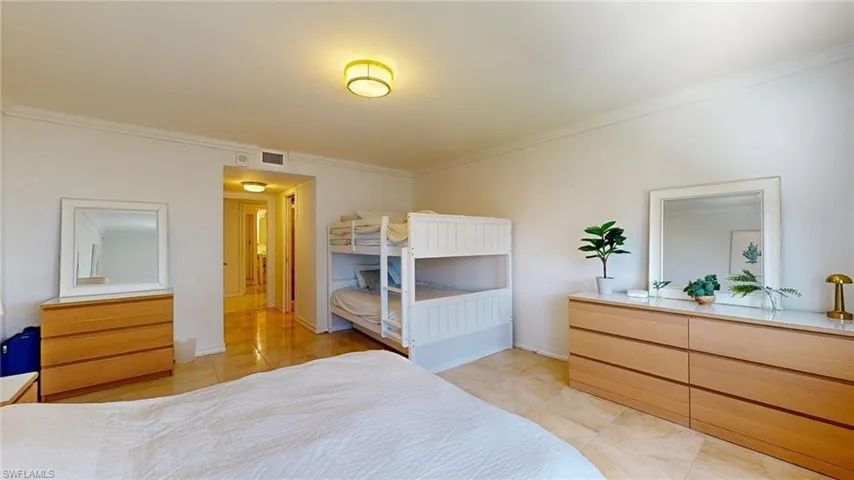 Bedroom featuring ornamental molding and light tile patterned flooring
