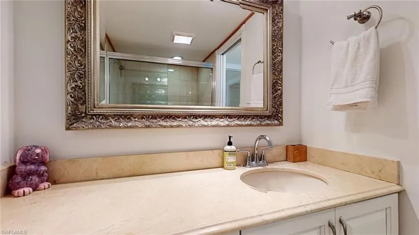 Bathroom featuring vanity and a stall shower