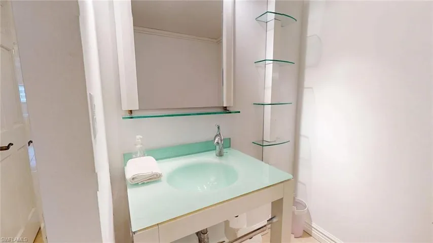 Bathroom with a sink and crown molding