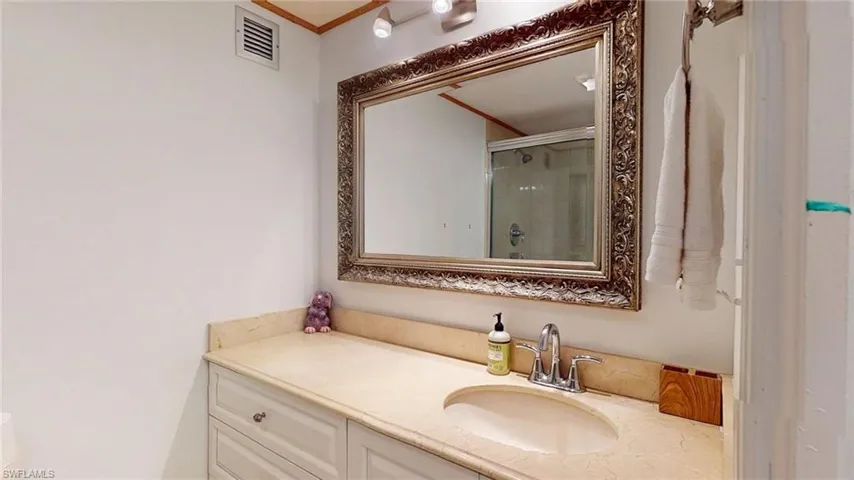 Bathroom with a shower stall and vanity