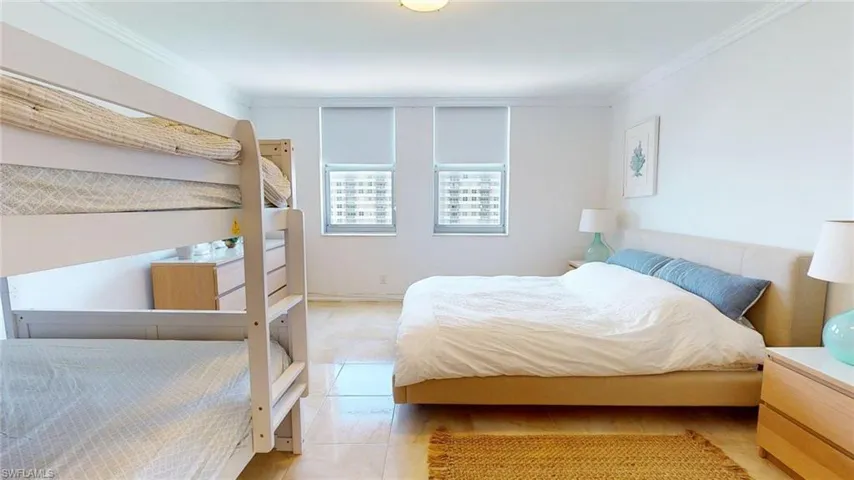 Bedroom featuring crown molding and tile patterned flooring