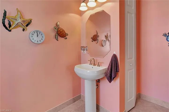 Bedroom featuring a closet, light tile patterned flooring, and ceiling fan