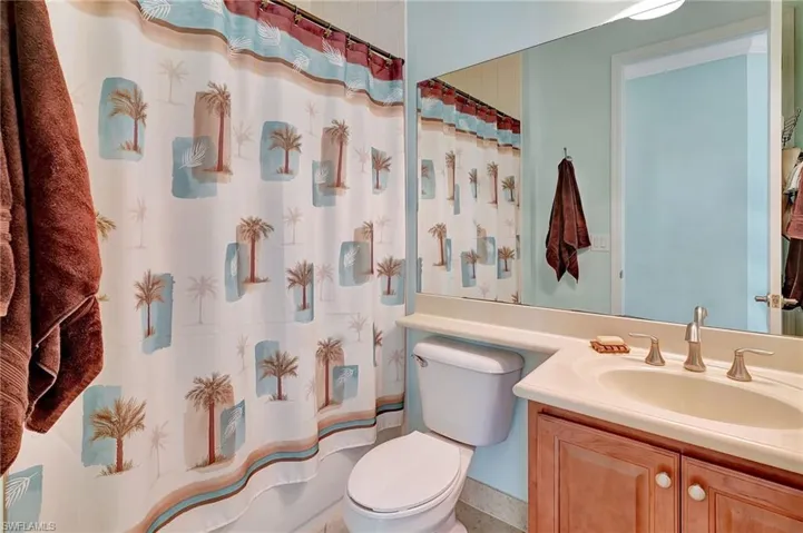 Bedroom featuring light tile patterned floors and a ceiling fan