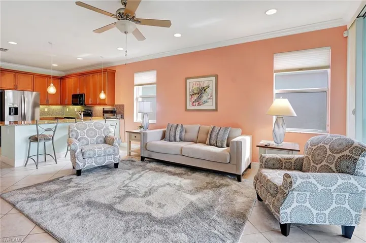 Bedroom with crown molding, light tile patterned floors, and ceiling fan