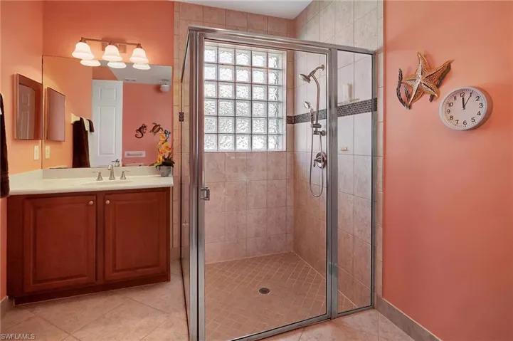 Bedroom with light tile patterned floors, a chandelier, and crown molding