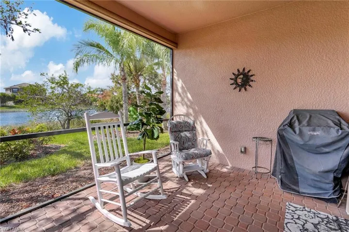 View of green lawn featuring a lanai and a water view