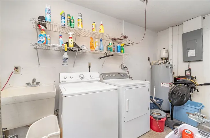 Laundry area with washer and dryer, sink, and electric water heater