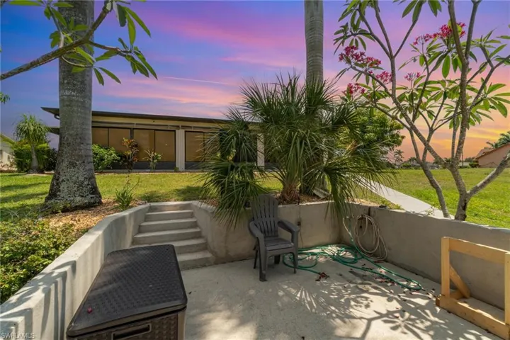 Patio terrace at dusk with a lawn