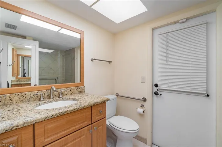 Bathroom featuring toilet and large vanity