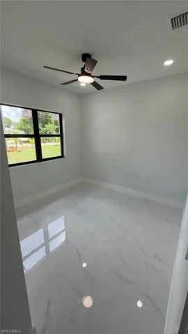 White tile flooring, recessed lighting, and a contemporary ceiling fan with integrated illumination