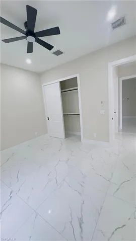 Room featuring large format porcelain tile flooring with marble-look veining