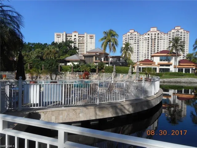 Surrounding community with a water view and a swimming pool