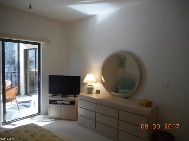 Bedroom featuring access to outside and light carpet