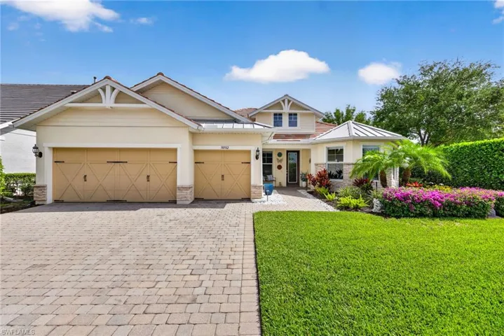 Craftsman house with a front lawn, decorative driveway, and a garage