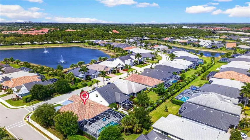 Aerial perspective of suburban area featuring a nearby body of water