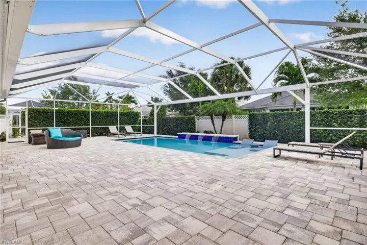 View of pool featuring a lanai, patio surround, and a sunroom