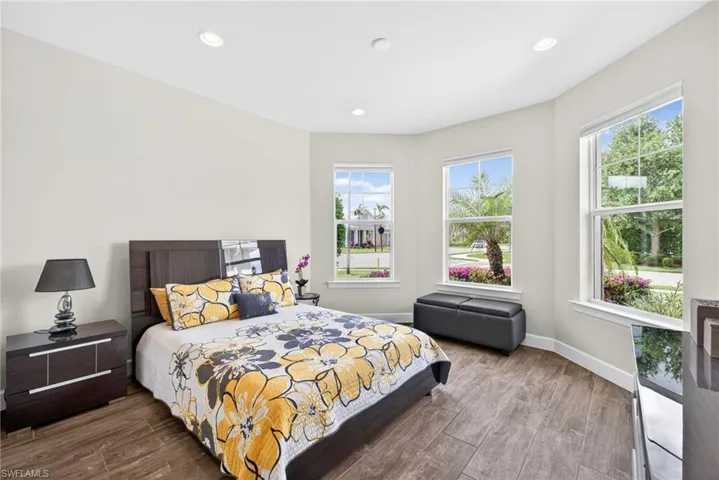 Bedroom featuring dark wood-style floors and recessed lighting