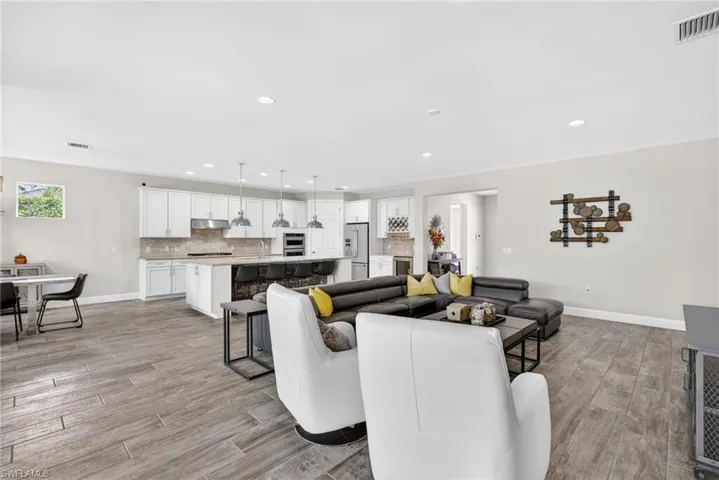 Living room featuring light wood finished floors and recessed lighting