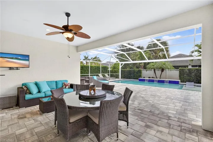 View of patio with a lanai, a sunroom, a ceiling fan, and outdoor lounge area