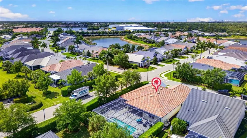 Aerial perspective of suburban area with a nearby body of water
