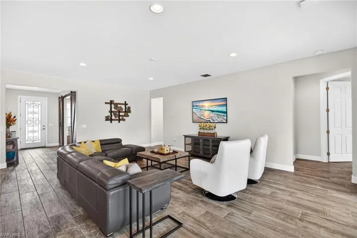 Living area featuring wood finish floors and recessed lighting