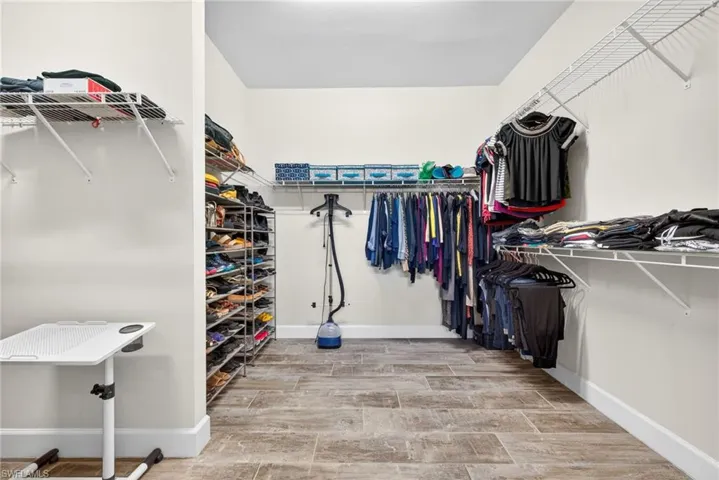 Walk in closet with wood tiled floors