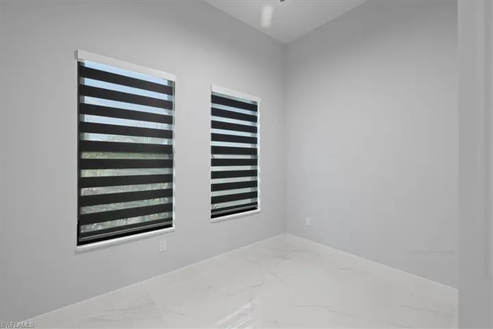 Empty room featuring light marble finish flooring