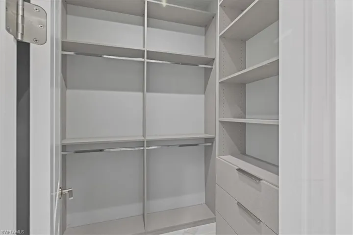 Spacious closet with marble finish floors