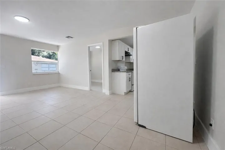 Empty room with light tile patterned flooring