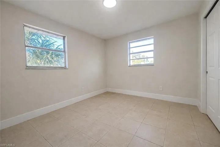 Unfurnished bedroom featuring a closet and light tile patterned floors
