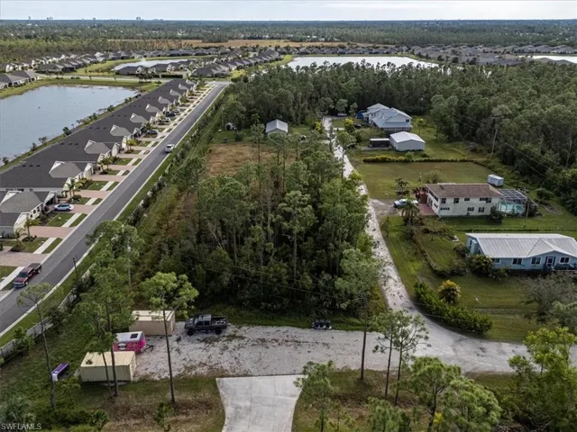 Birds eye view of property with a water view