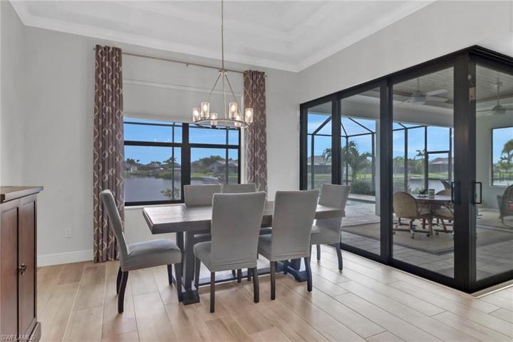 Dining room overlooking the pool and waterway. Notice the trey ceiling and crown molding.