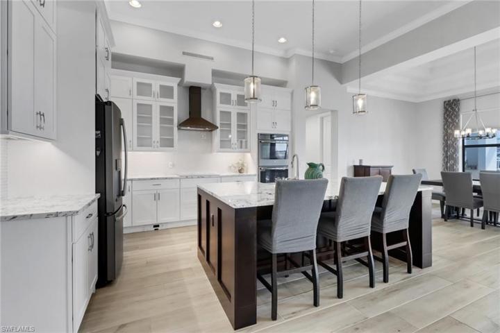 Level 5 granite counters, two toned custom cabinets, induction cook top, double wall ovens, pendant lighting, crown molding, tiled backsplash. Perfect place for entertaining!
