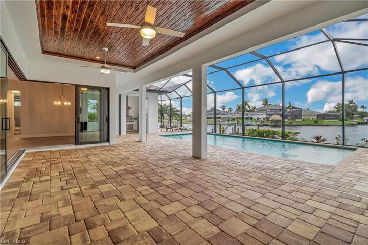Over sized lanai w/ tongue and groove trey ceiling and 90 degree sling and pocketing glass doors. Heated salt water pool w/ custom sun shelf overlooking the water. EWlectric Kevlor roll downs add extra safety and privacy.