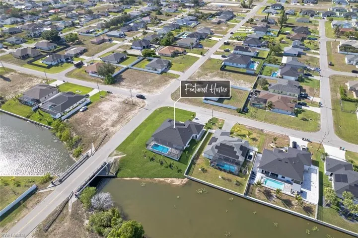 Aerial overview of property's location with nearby suburban area and a nearby body of water