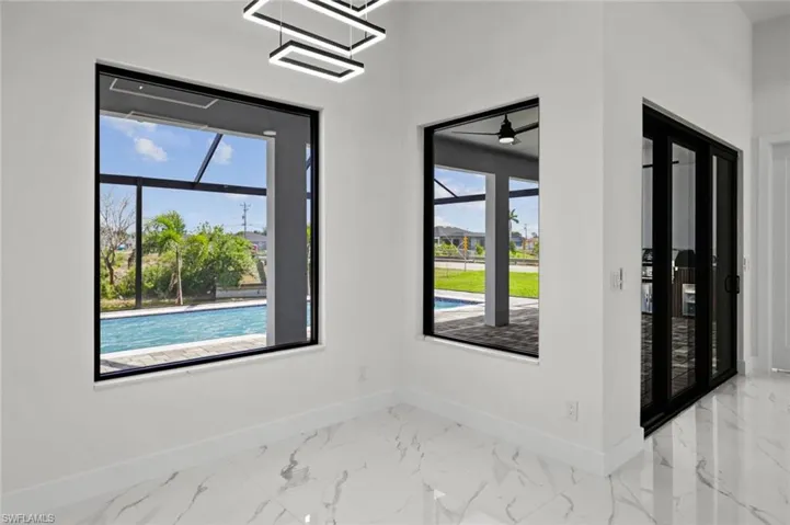 Spare room with baseboards and marble look tiles