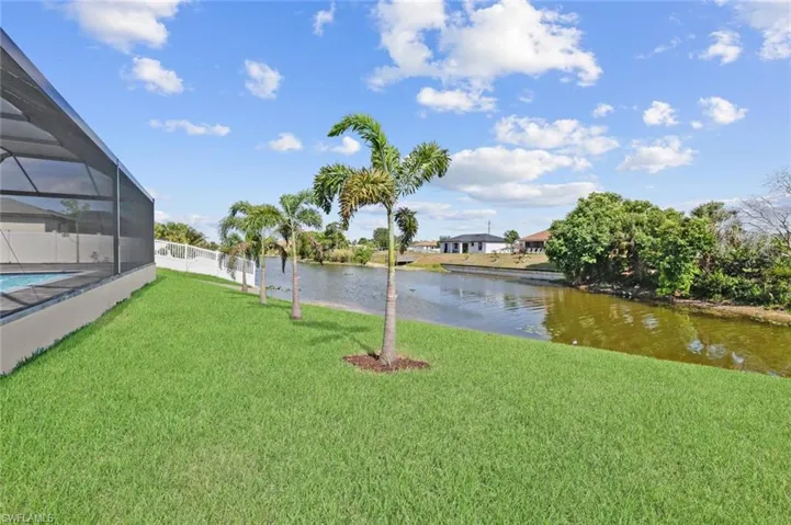 View of yard featuring a water view and a lanai