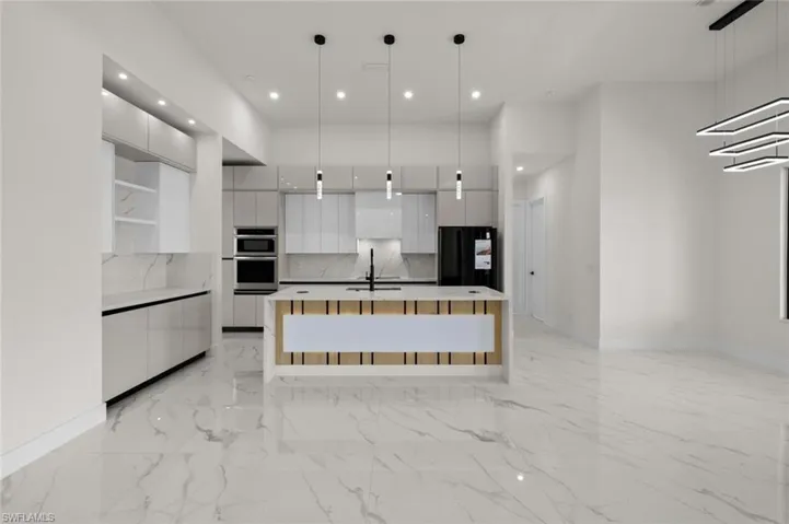 Kitchen featuring modern cabinets, white cabinets, freestanding refrigerator, recessed lighting, and double oven