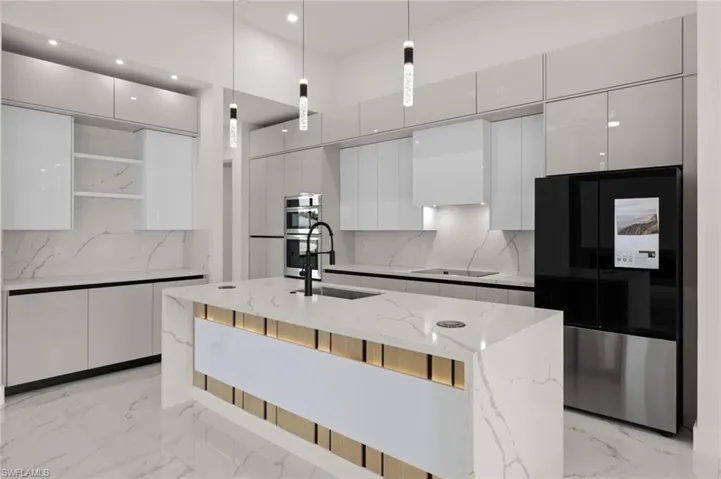 Kitchen with a sink, modern cabinets, smart refrigerator, open shelves, and white cabinetry